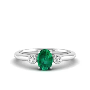 Prong-Set Oval Emerald and Bezel Diamond Ring